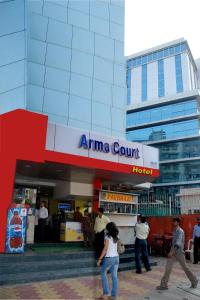 a group of people walking in front of a store at Hotel Arma Court in Mumbai