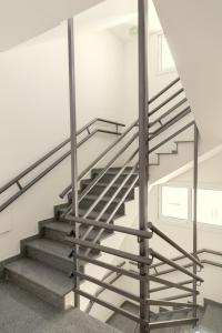 a staircase in a building with a metal railing at Oceania Bay Village in Pyla