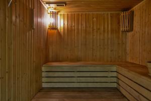a sauna with wooden walls and a wooden floor at Oceania Bay Village in Pyla