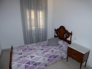 Łóżko lub łóżka w pokoju w obiekcie APARTAMENTOS DAYMA