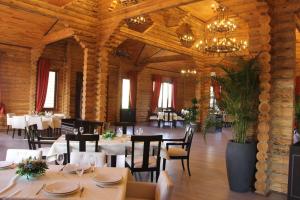 a dining room with tables and chairs and a chandelier at Khazar Inji in Baku