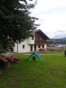 a yard with a slide in front of a house at Casa Maria in Vatra Dornei