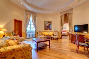 a living room with a couch and a tv at Schloss Lübbenau in Lübbenau