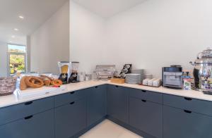 a kitchen with blue cabinets and a counter top at Isola 12 Hotel in Kas