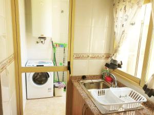a small kitchen with a sink and a washing machine at RUZAFA 17, OLD TOWN in Benidorm +26 photos