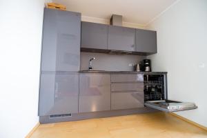 an empty kitchen with a stainless steel refrigerator at City center apartment Aida in Pärnu