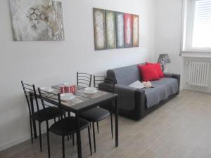 a living room with a table and a couch at Station Home in Sesto San Giovanni