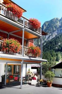 a building with flowers on the balconies of it at Biotel Bertel Naturappartements in Brand