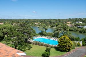 an aerial view of a swimming pool and a lake at Hôtel Maison Chiberta in Anglet