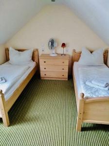 a room with two beds and a desk with a fan at Garni Hotel St Anna in Boží Dar