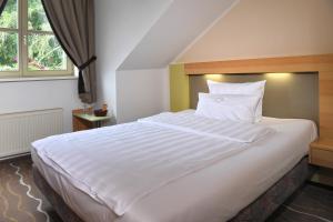 Postel nebo postele na pokoji v ubytování Landhotel Schnuck