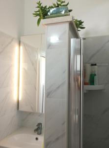 a bathroom with a sink and a mirror at The Potter's House overlooking the Bay of Haifa in Haifa