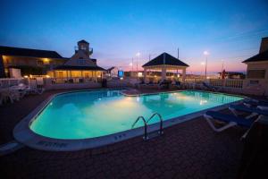 a swimming pool with a pool table and chairs at Hatteras Island Inn in Buxton