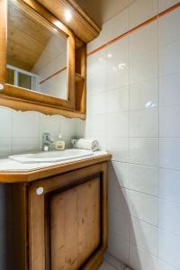 a bathroom with a sink and a mirror at Apartment Le Kandahar in Les Houches