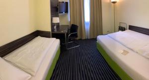Voodi või voodid majutusasutuse Behringers City Hotel Nürnberg toas