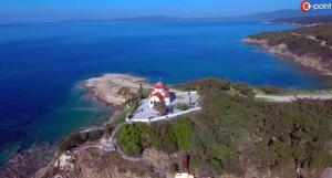 an aerial view of a house on an island in the water at MAGDA APARTMENTS in Nea Roda