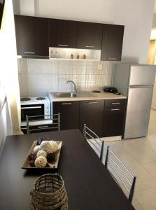 a kitchen with a table with a tray of food on it at MAGDA APARTMENTS in Nea Roda