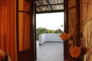 an open door with a view of a patio at Galini in Agia Irini Milos