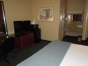 a hotel room with a bed and a television at Travelodge by Wyndham Silver Spring in Silver Spring