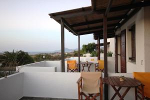 a balcony of a house with a table and chairs at Galini in Agia Irini Milos
