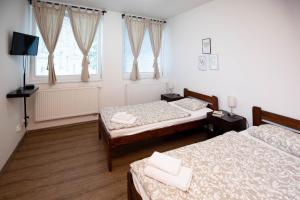 Posteľ alebo postele v izbe v ubytovaní Žižkov Cosy Studio Apartments