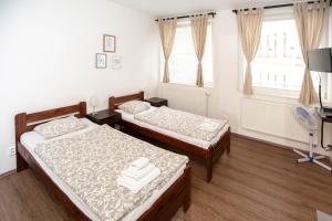 Posteľ alebo postele v izbe v ubytovaní Žižkov Cosy Studio Apartments