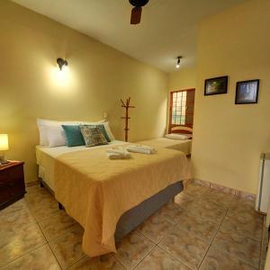a bedroom with a large bed and a window at Pousada do Sol in Brotas
