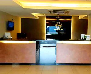 a restaurant with a counter in a room at Harbour Inn in Melaka