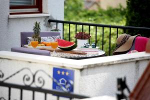 a table with fruit and drinks on a balcony at Modern Apartment in Primošten in Primošten +37 photos