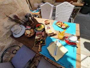 a wooden table with food on top of it at LUXOR Hvar - Main Square Apartments in Hvar +69 photos