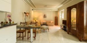 a kitchen and living room with a table and chairs at Hydras Chromata in Hydra