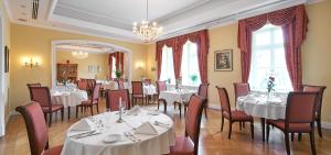 a dining room with white tables and chairs at Castle Hotel Grof Degenfeld Superior in Tarcal