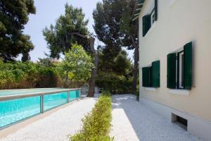 a house with a swimming pool next to a building at Glyfada Villa 6BR 16ppl Private Pool 300m to Beach in Athens