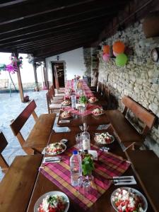 a long table with plates of food on it at Guest House Popov in Marchevo