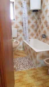 a bathroom with a tub and a zebra print rug at Villa Letina in Sukošan +53 photos