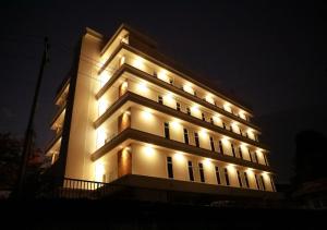 a large building with lights on it at night at Ashoka Inn Chottanikkara in Chottanikara