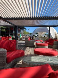 a patio with chairs and red cushions on a deck at Holiday Marina Resort in Grimaud +83 photos