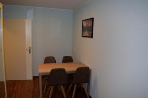 Habitación con mesa de madera y 4 sillas. en Trip Inn Residence City Center en Frankfurt