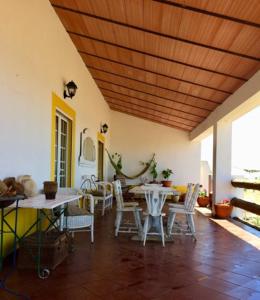 a dining room with tables and chairs and a wooden ceiling at Monte da Figueira in Amareleja