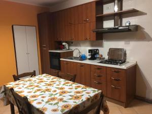 a kitchen with a table and a stove top oven at Un nido sul lago in Ranzanico +26 photos