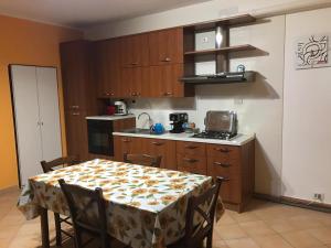 a kitchen with a table with a table cloth on it at Un nido sul lago in Ranzanico