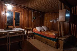 a bedroom with a bed and a sink in it at Chalet Gasparjeva Velika Planina in Kamnik