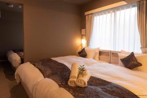 Postel nebo postele na pokoji v ubytování Framboise KYOTO Hotel de charme