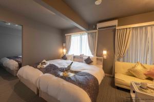 Postel nebo postele na pokoji v ubytování Framboise KYOTO Hotel de charme