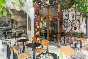 a restaurant with tables and chairs and a brick wall at Cheers Hostel in Istanbul