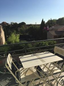 a white table and chairs sitting on a balcony at Escale à Saint-Tropez in Saint-Tropez