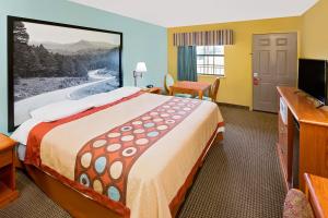a hotel room with a large bed and a flat screen tv at Super 8 by Wyndham Hazen in Hazen