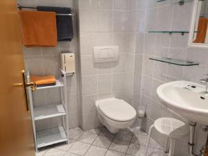a bathroom with a toilet and a sink at Hotel Auszeit in Sankt Kanzian