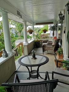 a patio with a table and chairs on a porch at Your Oasis in Niagara Falls Canada in Niagara Falls