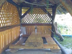 a wooden table in a gazebo at PetrikHolm in Tatariv